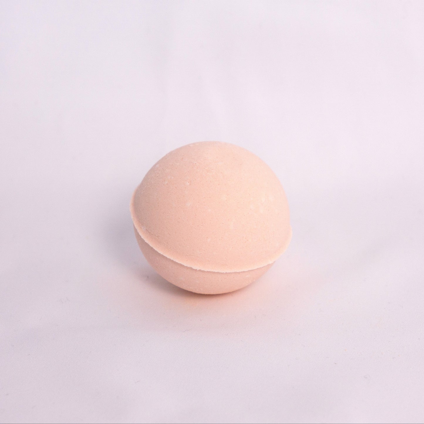 Sweet orange and pink grapefruit Bubble Bath Bomb with creamy texture, hand-pressed and infused with juicy fruity orange and grapefruit essential oils for a revitalizing aromatherapy bath
