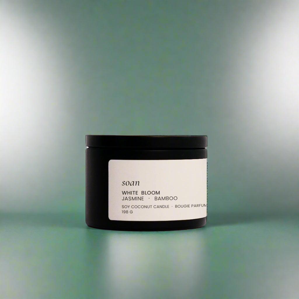 White Bloom tin candle with smooth soy-coconut wax, hand-poured and scented with jasmine, bamboo, and evergreen