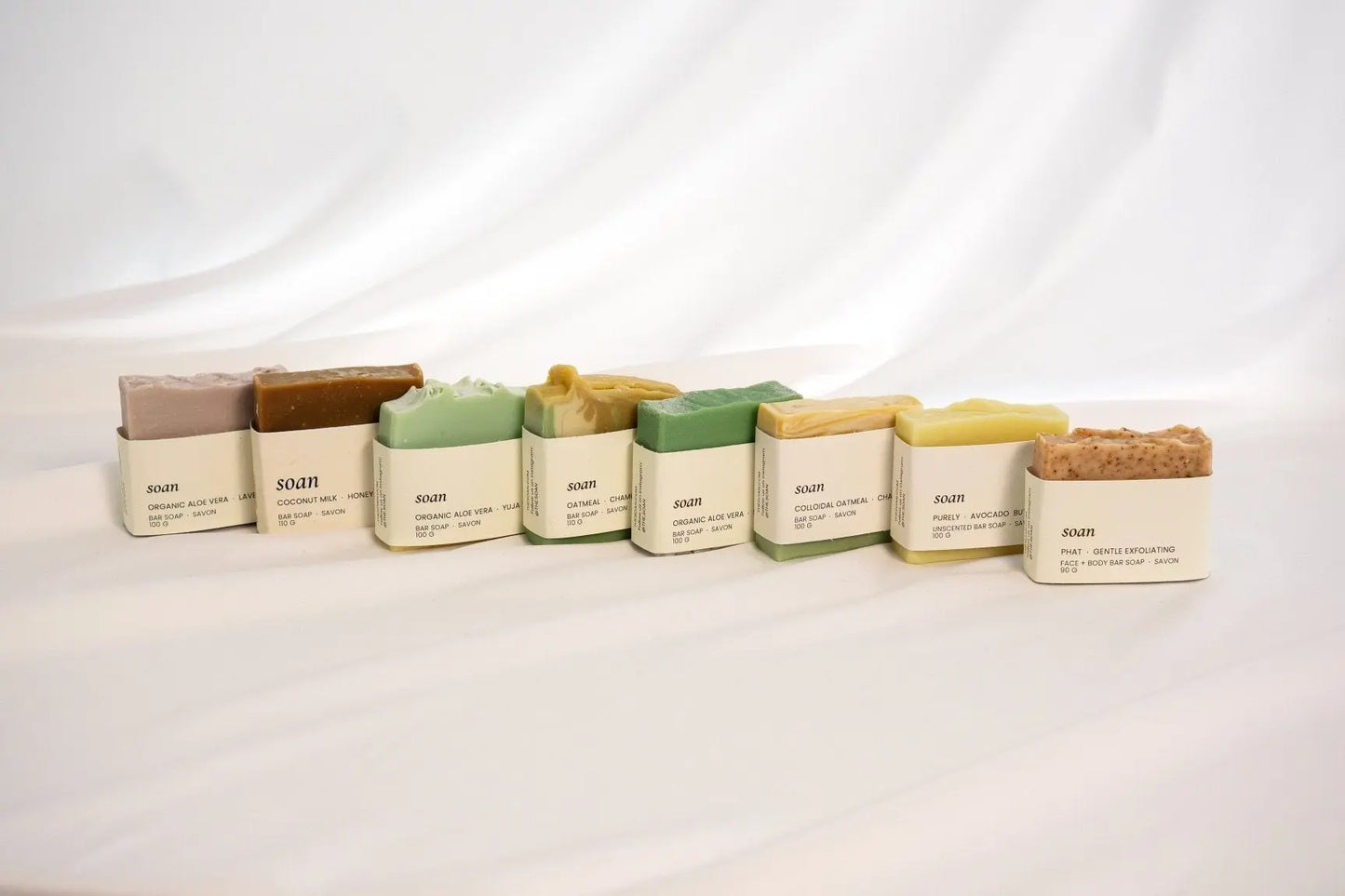 Assorted handmade soap collection featuring natural bars with botanical ingredients, crafted for gentle cleansing and skin nourishment