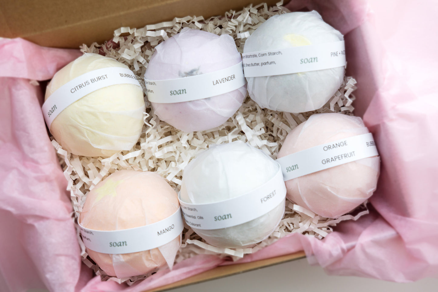 Set of bath bombs in a box with pink tissue paper