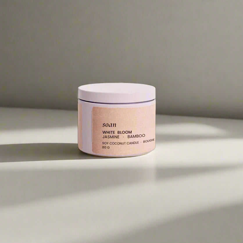 Close-up of White Bloom candle label and creamy wax, crafted for a calming floral-green home fragrance