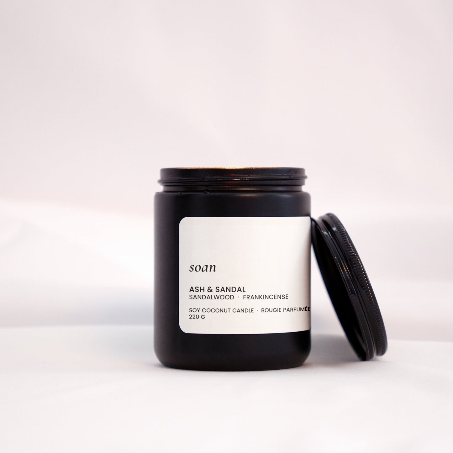 Candle jar with a label on a white background