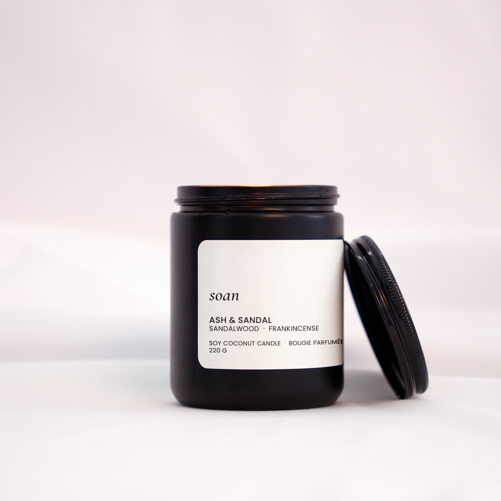 Candle jar with a label on a white background
