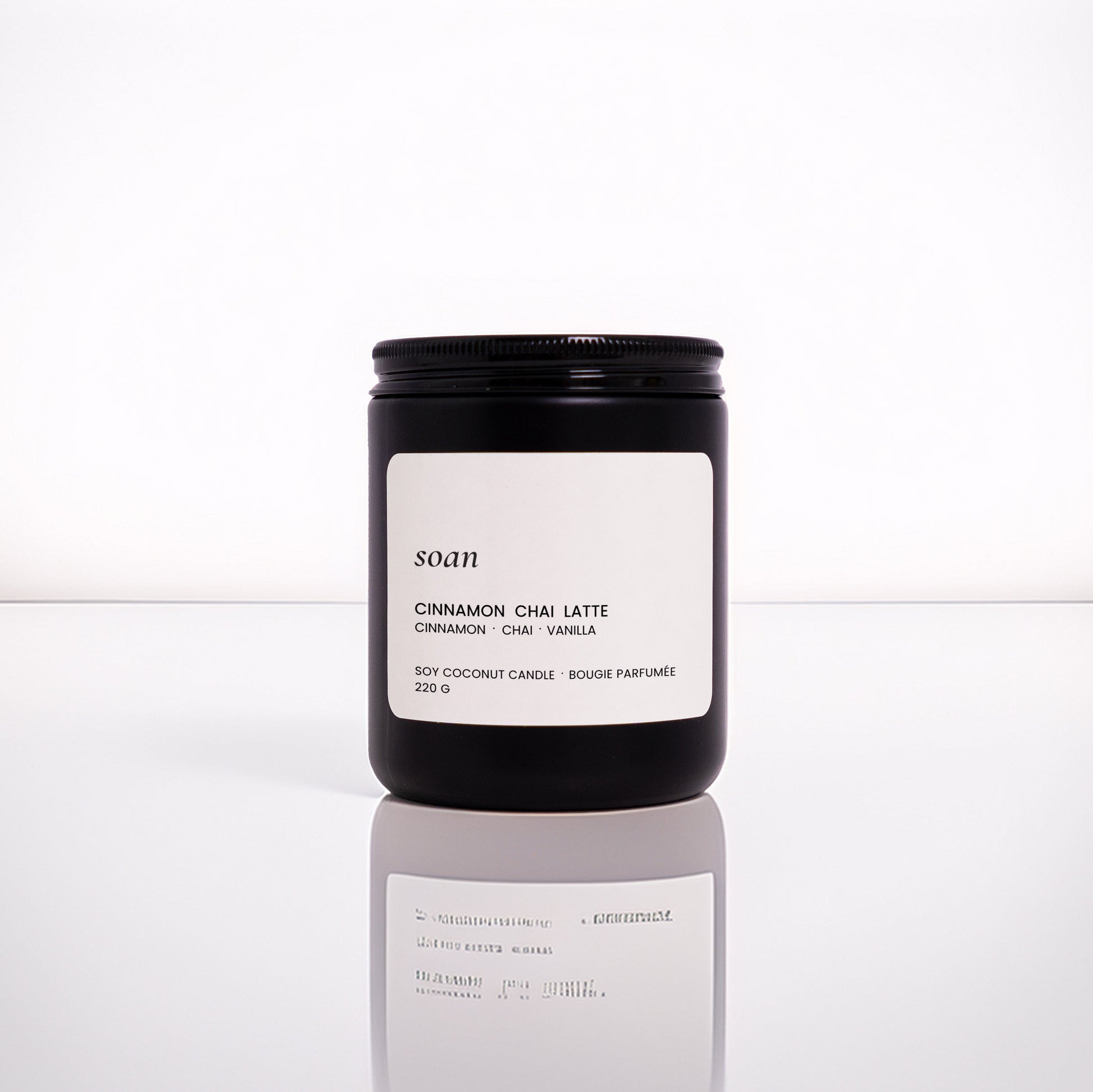 Cinnamon Chai Latte jar candle in matte black vessel with wooden wick, hand-poured with soy-coconut wax and spiced vanilla scent