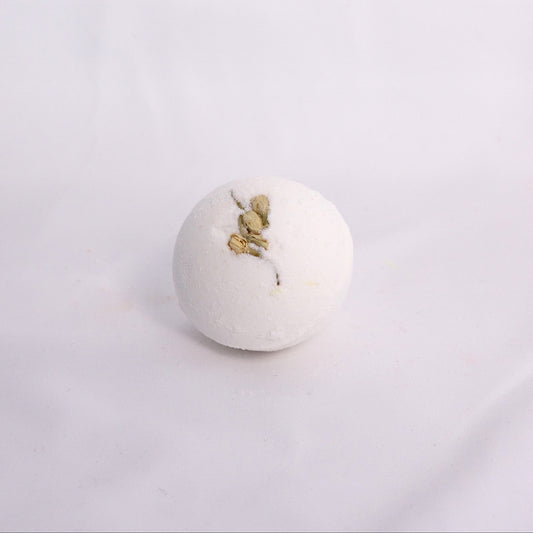 Close-up of Jasmine bath bomb on a clean surface, crafted with milk powder, shea butter, and avocado oil for soft hydration