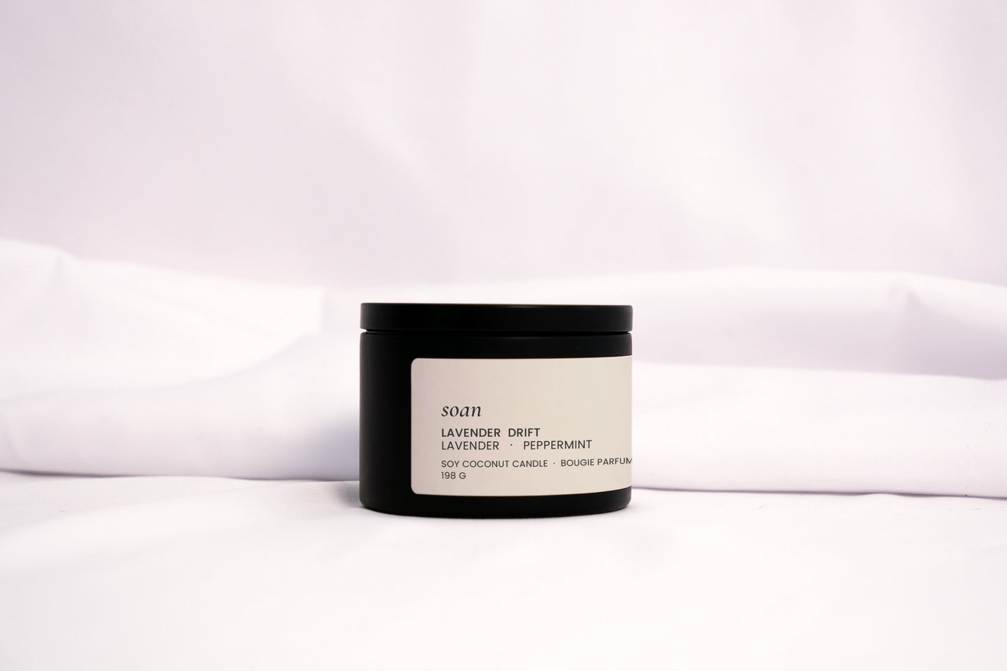 Minimalist Lavender Drift candle styled with soft linen and natural light, evoking a peaceful self-care ritual