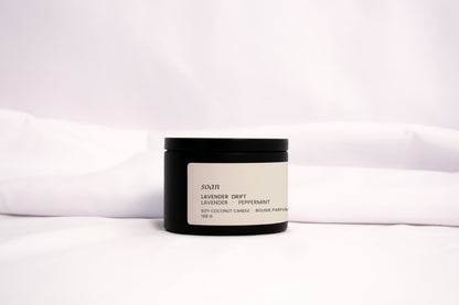 Minimalist Lavender Drift candle styled with soft linen and natural light, evoking a peaceful self-care ritual