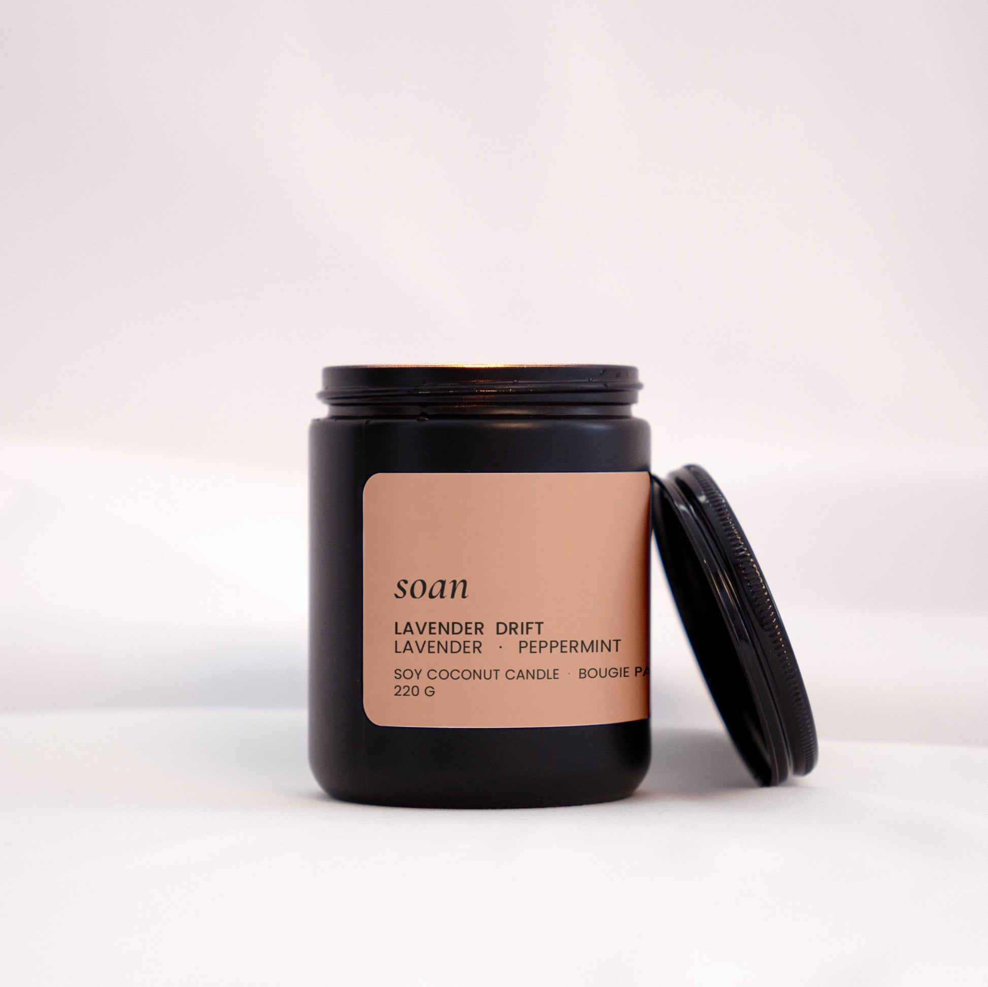 Candle jar with a brown label on a white background