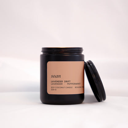 Candle jar with a brown label on a white background