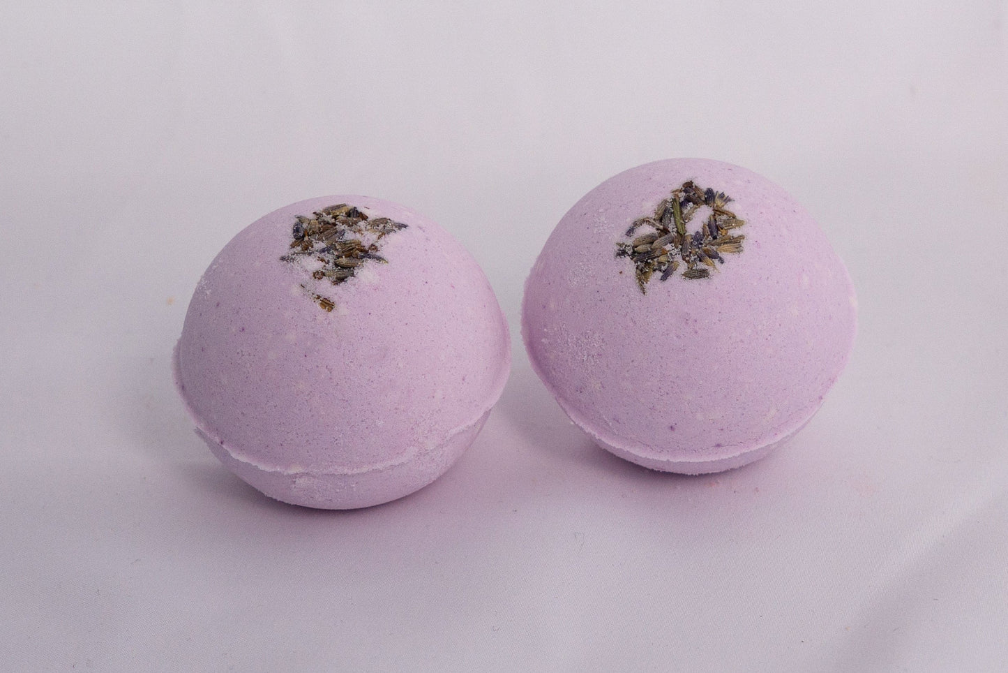 Lavender bath bomb with natural texture, hand-pressed and infused with relaxing aromatherapy bath