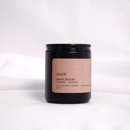 White Bloom soy candle in a clean glass jar, hand-poured with jasmine, bamboo, and evergreen scent