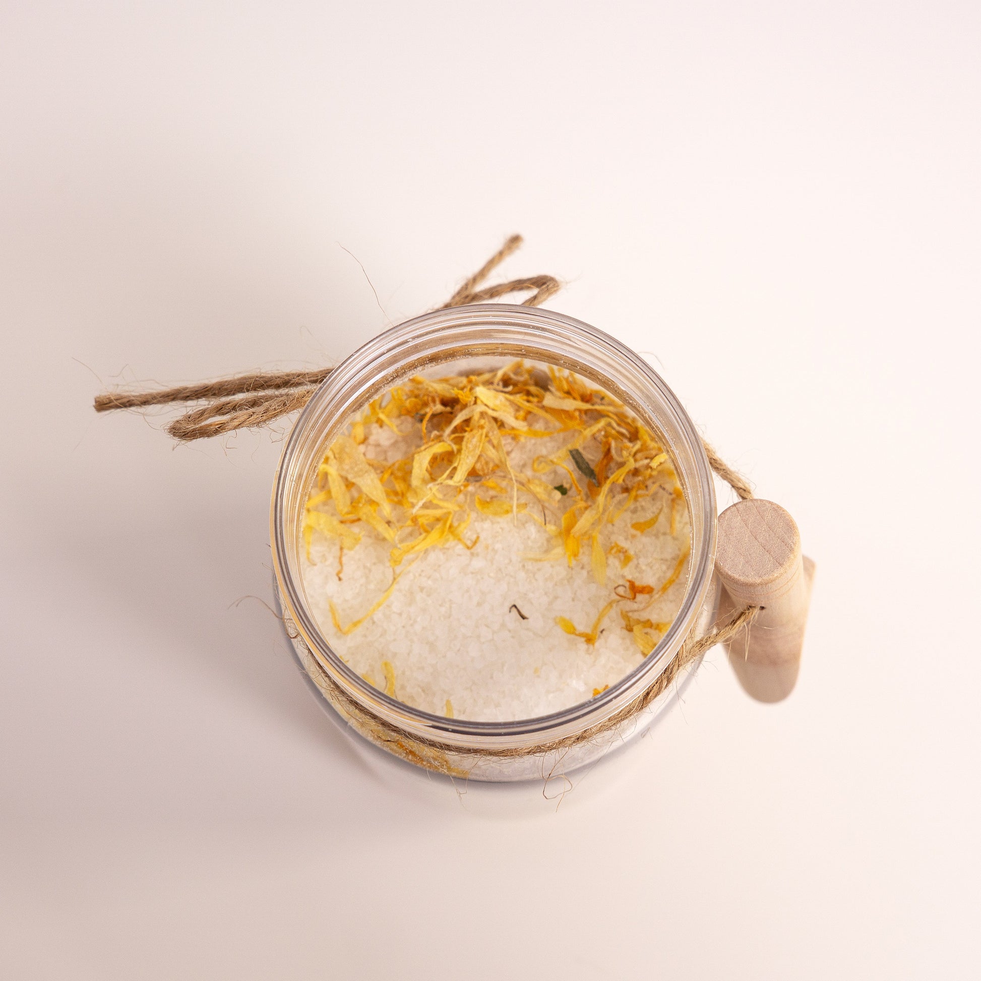 Jar of bath salts with decorative elements on a light background