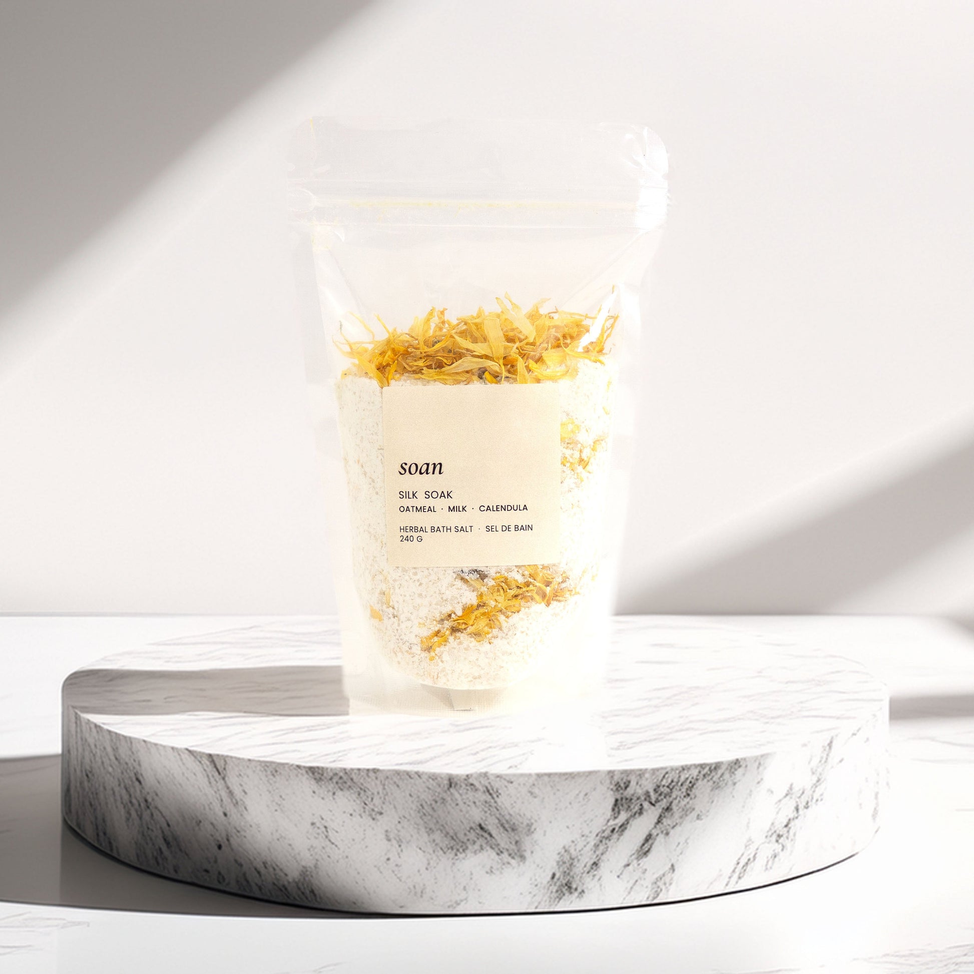 Silk Soak Bath Salt on a marble stand with soft lighting