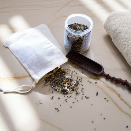 Close-up of muslin bag filled with bath salts and dried herbs, designed for a calming and clean bathing ritual