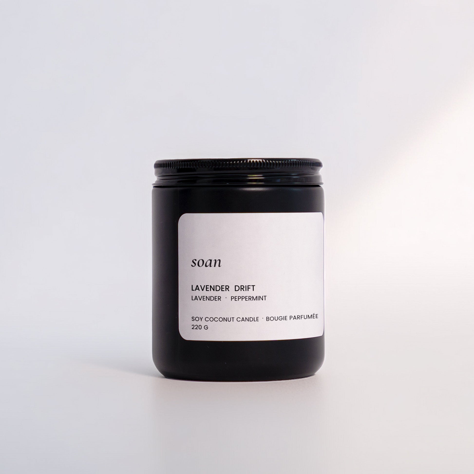 Candle jar labeled 'soam' with 'Lavender Drift' on a white background