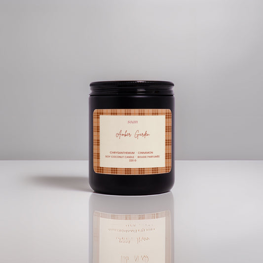 Candle with a label on a reflective surface and gray background