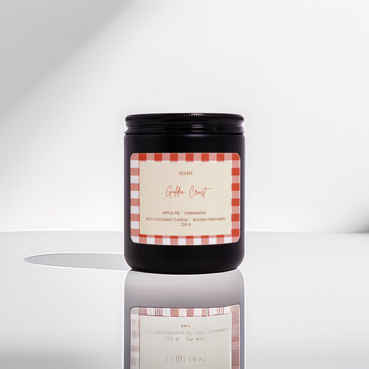 Candle with a checkered label on a reflective surface