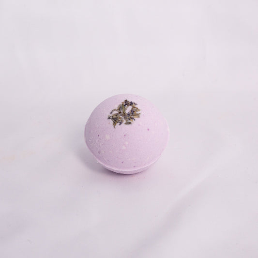 Close-up of Lavender bath bomb on a clean surface, crafted with milk powder, shea butter, and avocado oil and lavender essential oil for soft hydration and aromatherapy bath