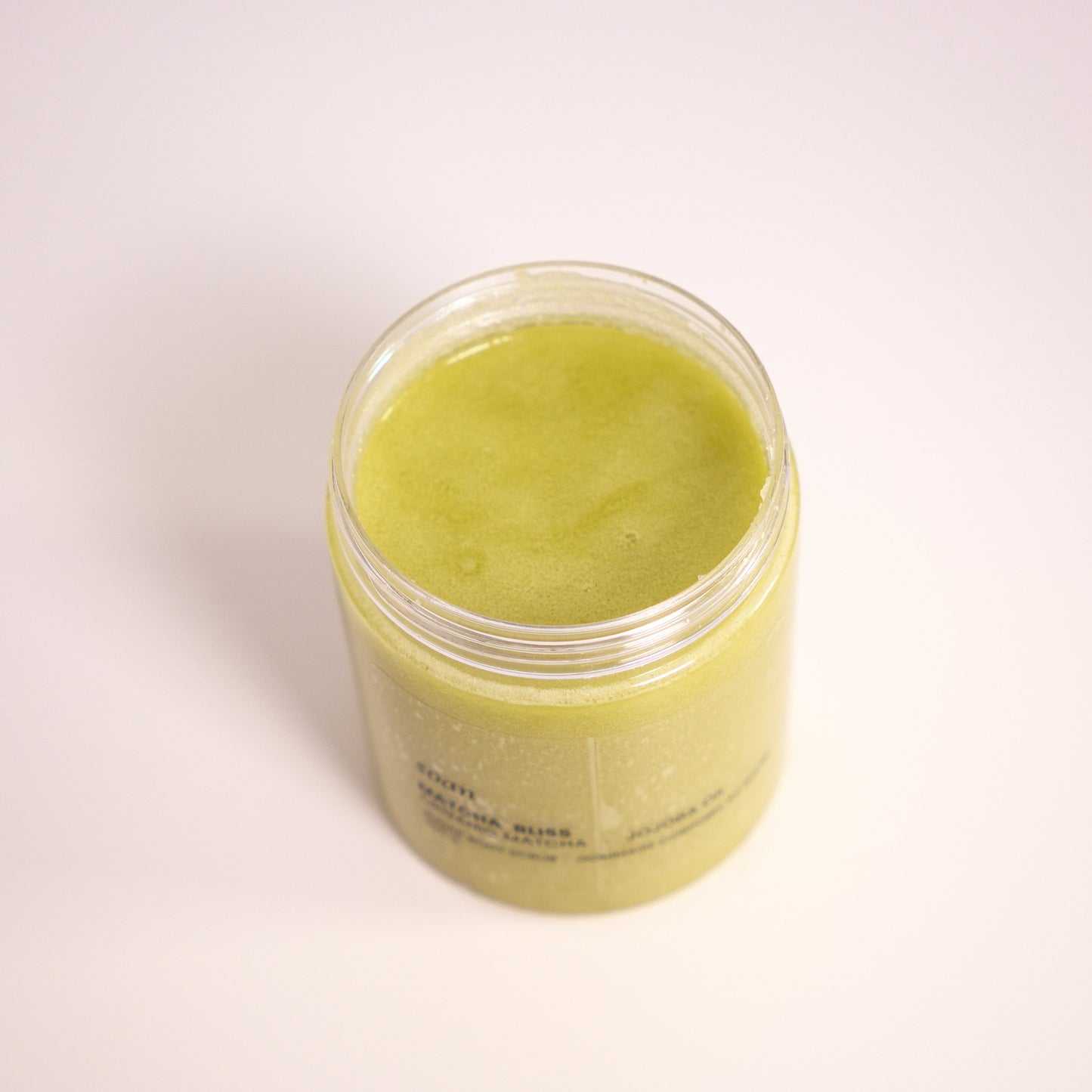 Jar of green tea sugar scrub on a white backgrounds