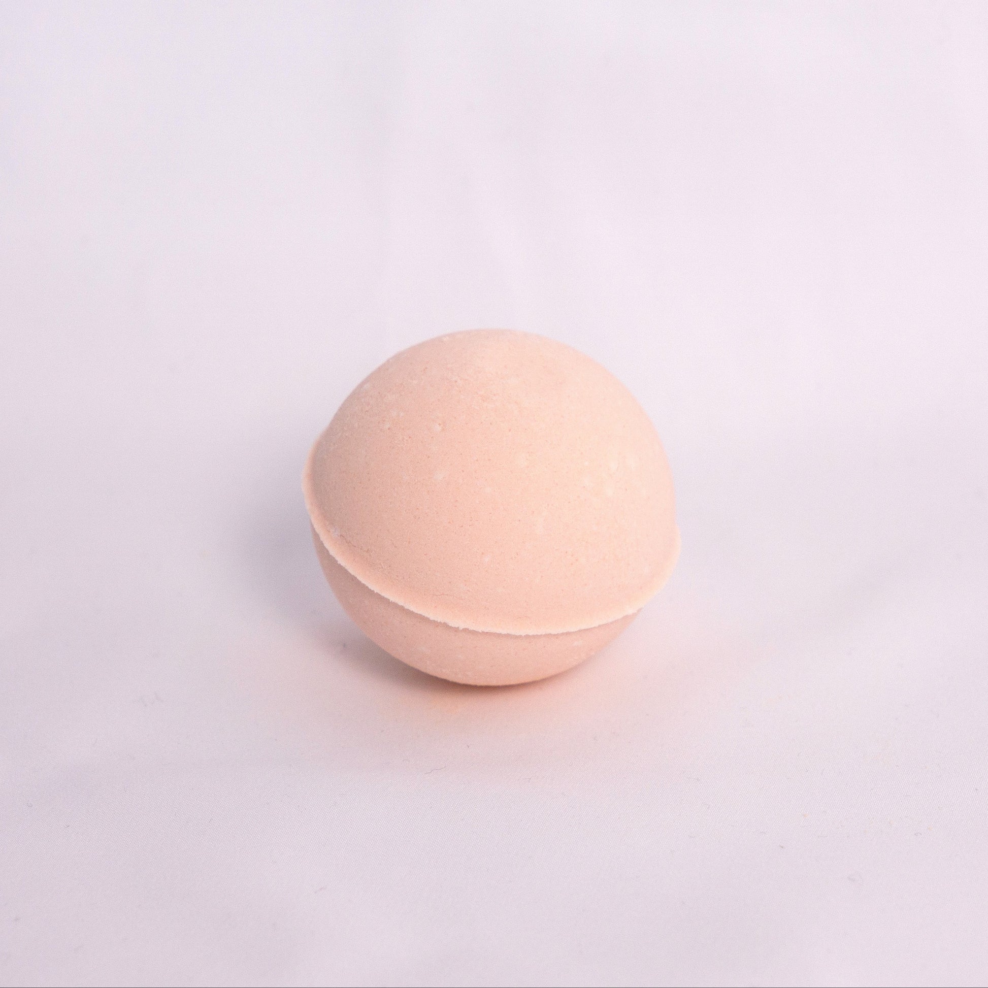 Sweet orange and pink grapefruit Bubble Bath Bomb with creamy texture, hand-pressed and infused with juicy fruity orange and grapefruit essential oils for a revitalizing aromatherapy bath