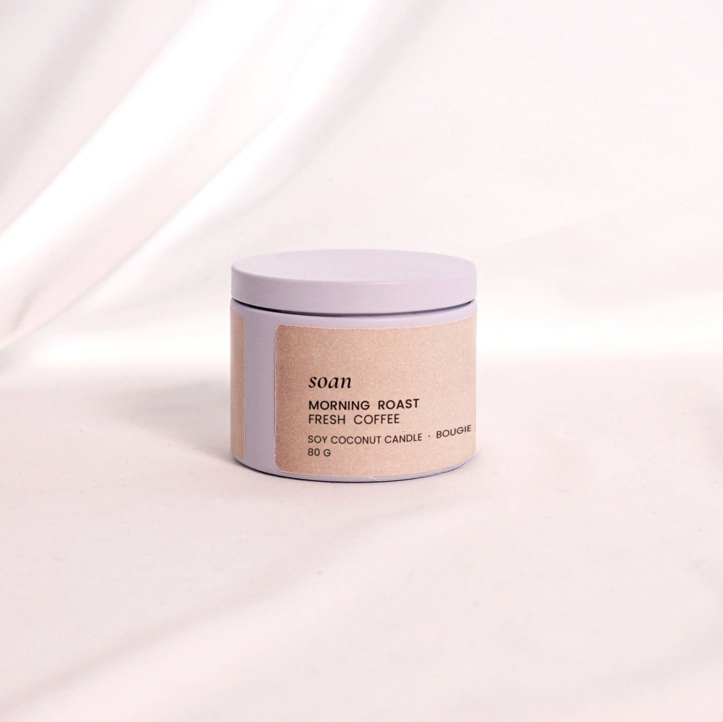 Close-up of Morning Roast candle label and tin container, evoking the scent of freshly brewed coffee in a portable form