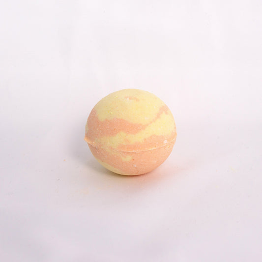 Fizzing Yuja bath bomb in water, releasing creamy bubbles and a fresh citrus yuzu aromas