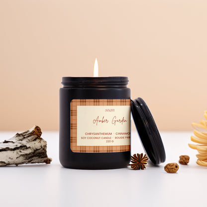Candle in a decorative jar with a label, surrounded by decorative elements on a light background