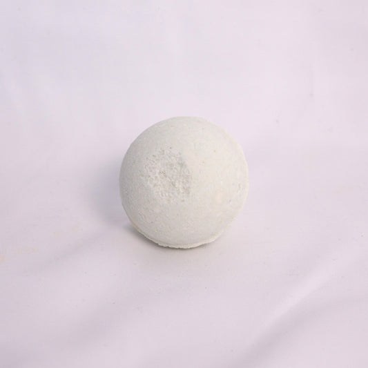Fizzing forest bath bomb in water, releasing earthy bubbles with notes of cedar, pine, and fresh greenery