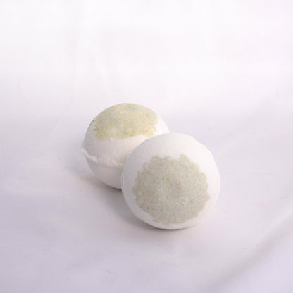 Fizzing mint eucalyptus bath bomb in water, releasing earthy bubbles with notes of peppermint and eucalyptus aromatherapy bath