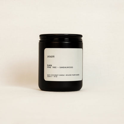 Candle jar with a label on a beige background