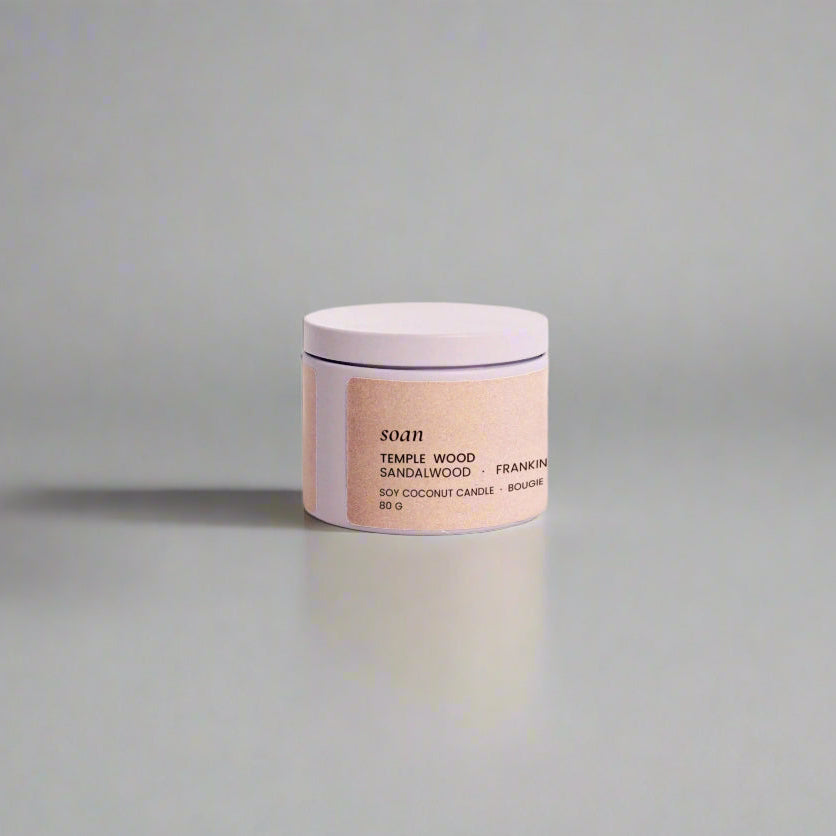 Temple Wood candle tin open to reveal smooth soy-coconut wax, ideal for portable calm and daily rituals