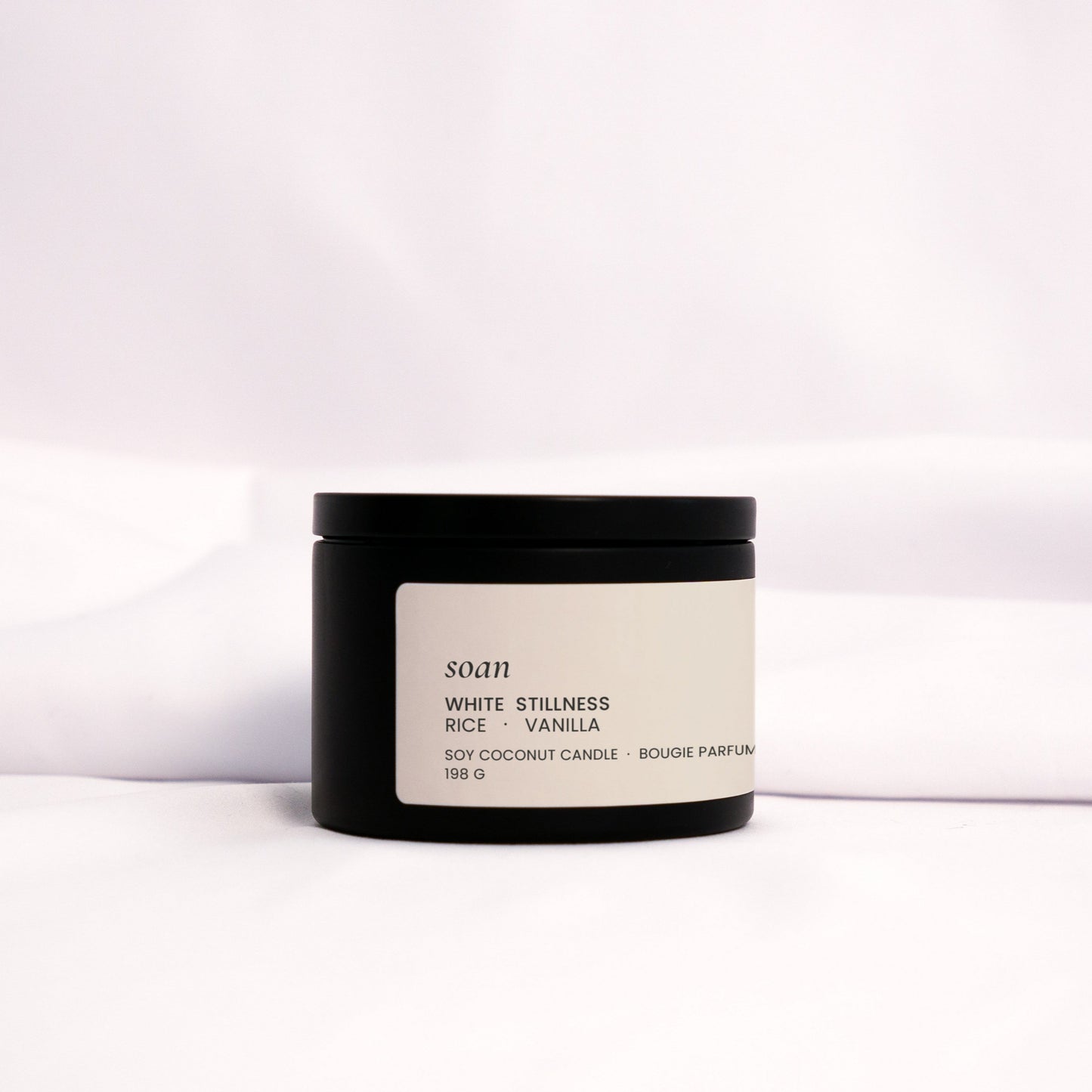 Minimalist White Stillness tin candle styled for cozy, quiet rituals with a creamy and nostalgic scent

