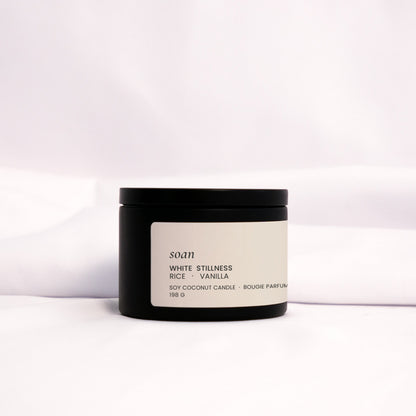 Minimalist White Stillness tin candle styled for cozy, quiet rituals with a creamy and nostalgic scent


