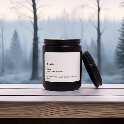 Candle with a label on a windowsill with a forest background