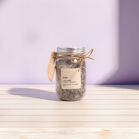 Jar of bath salts on a wooden surface with a purple background