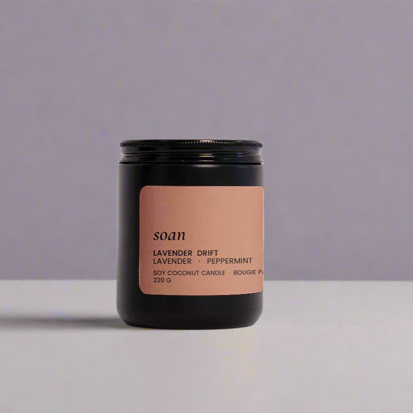 Candle jar with a brown label on a white background