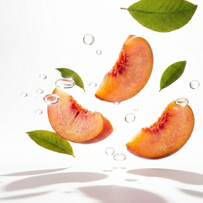Sliced peaches with leaves on a white background