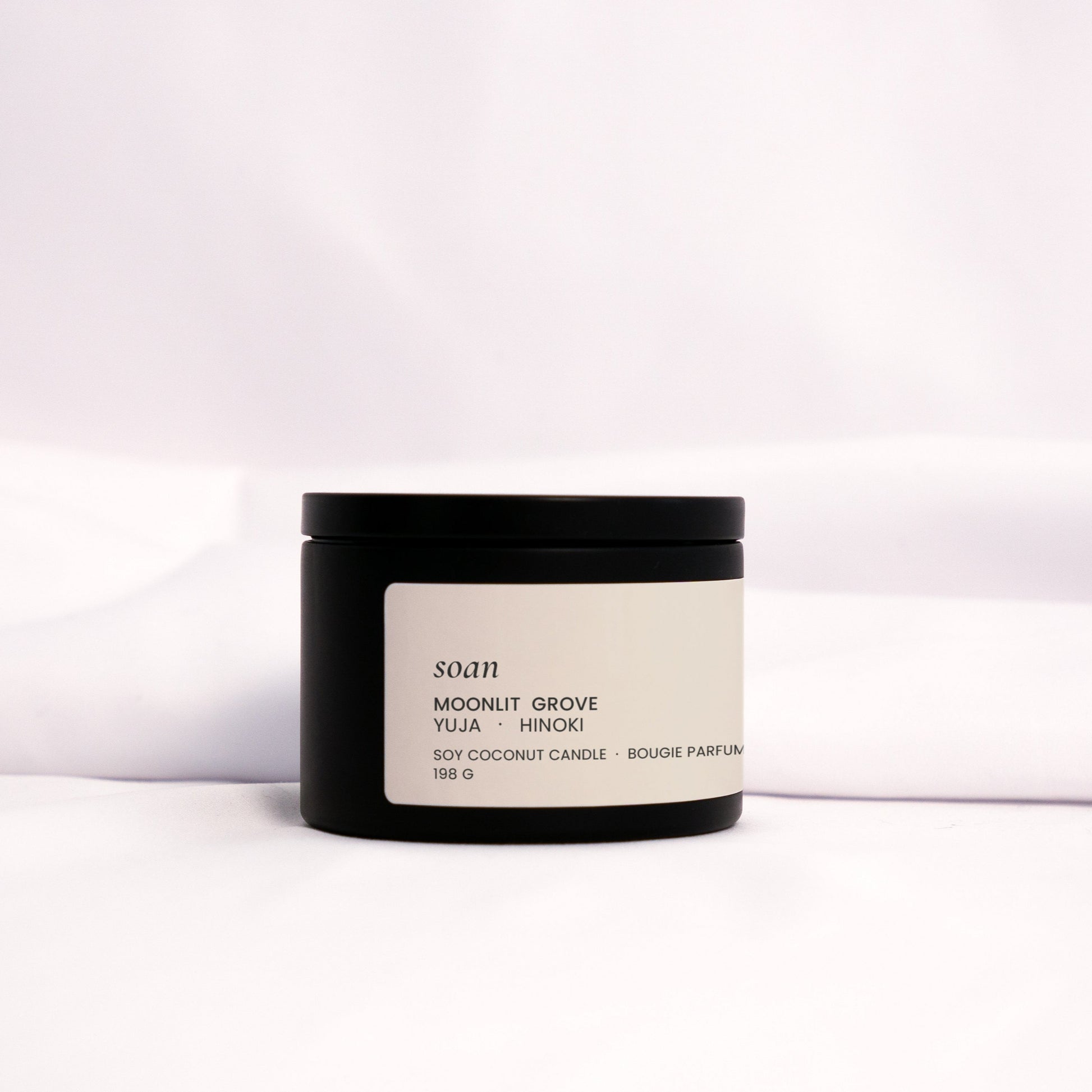 Moonlit Grove soy candle in a soft matte jar, hand-poured with notes of cypress, neroli, and amber