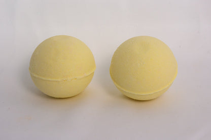 Citrus-scented bath bomb on a neutral surface, crafted with essential oils and skin-softening ingredients for an uplifting soak